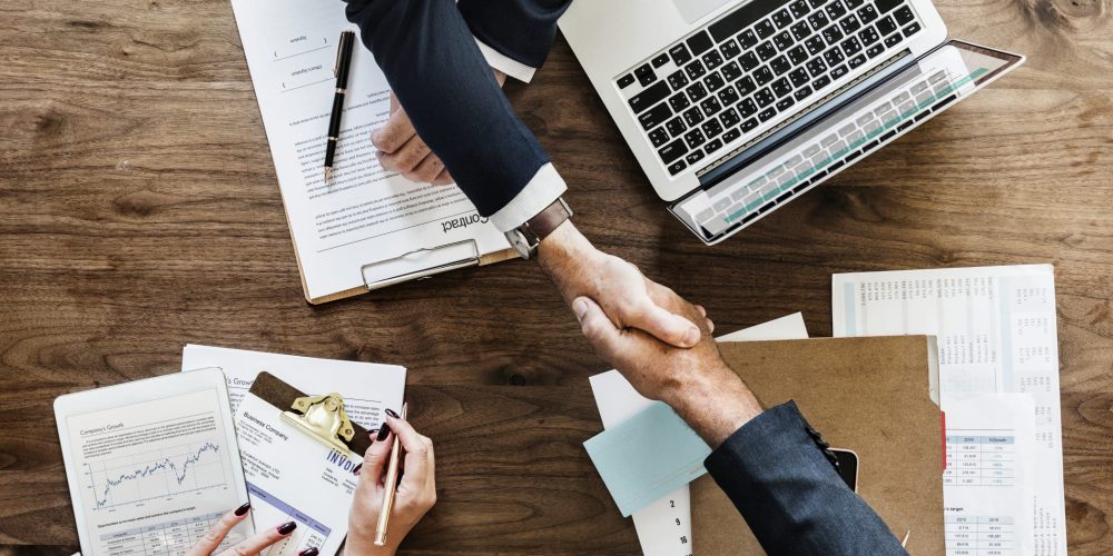 Business People Shaking Hands. The Handshake Represents The Collaboration Between Zirous And Zendesk.