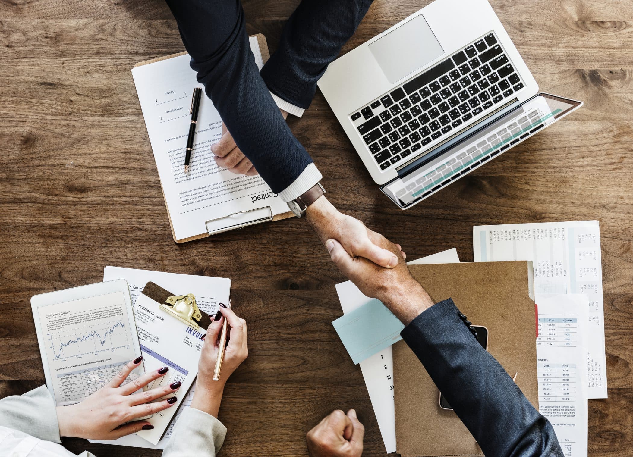 Business people shaking hands. The handshake represents the collaboration between Zirous and Zendesk.