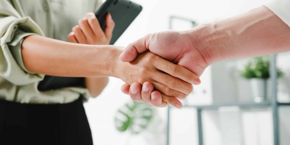 Professionals Shaking Hands To Represent A Partnership