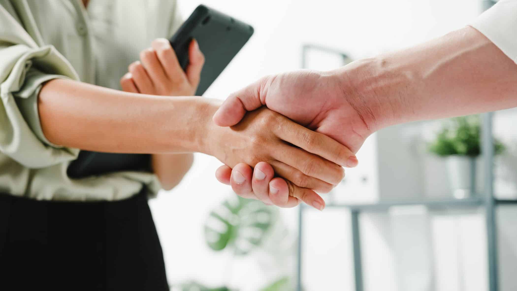 Professionals shaking hands to represent a partnership